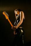 Female guitarist playing on stage