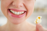 Closeup on smiling young woman with popcorn