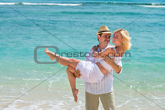 Happy young couple enjoying at beach
