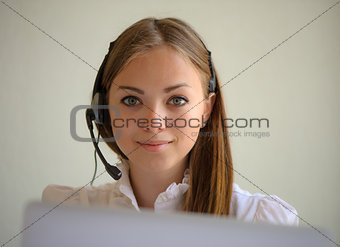 portrait of the girl of the operator with a font and the laptop