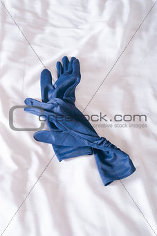 blue gloves on bed