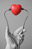 Hand with stethoscope and a heart