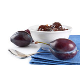 Ripe plums, jam and spoon