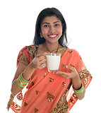 Indian woman in sari drinking milk