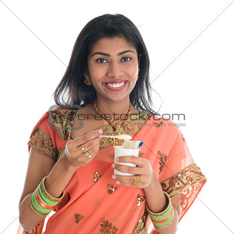 Traditional Indian woman eating yogurt
