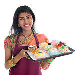 Traditional Indian woman baking cupcakes 