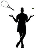 silhouette  man tennis player standing throwing ball and racket