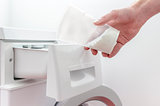 Pouring detergent into the washing machine