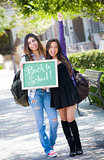 Mixed Race Female Students Holding Chalkboard With Back To Schoo