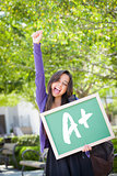 Mixed Race Female Student Holding Chalkboard With A+ Written