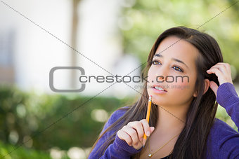 Pensive Mixed Race Female Student with Pencil on Campus