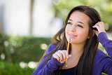 Pensive Mixed Race Female Student with Pencil on Campus