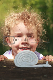 Smiling little girl with lovely curly blond hair