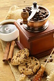 Still life of wooden coffee grinder, sugar, biscuits