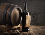Red wine bottle and old barrel