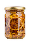 Glass jar filled with honey, nuts and fruits