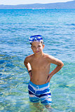 Cute eleven years old boy staying in the sea