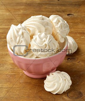 cookies meringue (whipped egg whites and sugar) on a wooden table
