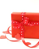 red gift box with ribbon and hearts on a white background