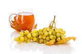 Glass of wine with grapes and leaves