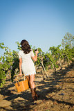 Young Woman Enjoying A Walk and Wine in Vineyard