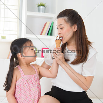 Kid feeding mum ice cream
