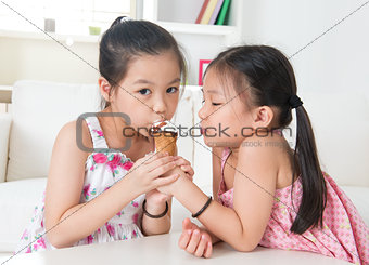Asian kids eating ice cream cone