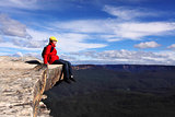 Sitting on Top of the World - hiker rests and admires views of B