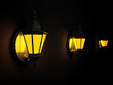 street lanterns on a wall at dark night