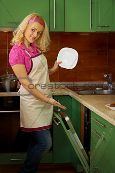 Young woman near the dishwasher