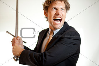 Crazy businessman attacking with a sword