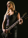 Sexy blond female playing electric guitar
