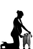 pregnant woman holding baby clothes