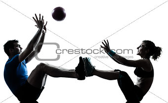 man woman exercising workout tossing fitness ball