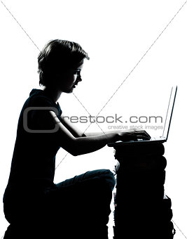 one young teenager boy or girl silhouette computer computing lap