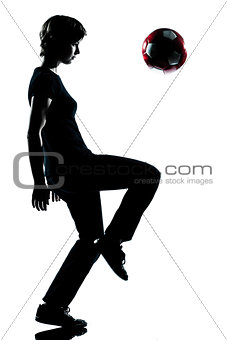 one young teenager boy silhouette juggling soccer football