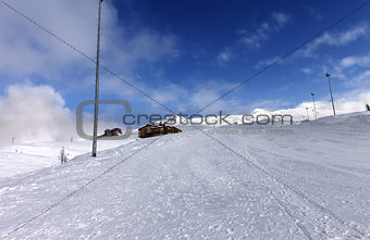 Ski slope and hotels in winter mountains