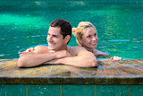 Happy smiling couple in swimming pool
