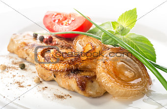 Pork steak with tomato and onion