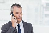 Concentrated businessman posing while having a phone call