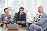 Business people smiling at camera while having a meeting