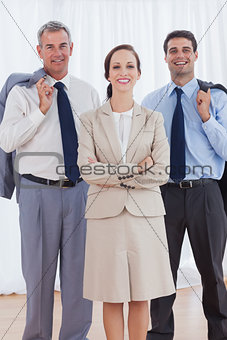 Cheerful businesswoman posing with her work team