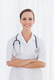 Smiling nurse with arms crossed looking at camera