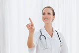 Smiling nurse posing pointing at something
