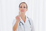 Concentrated nurse posing pointing at something