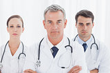 Serious doctors posing together crossing arms