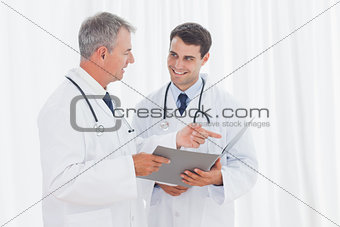 Smiling doctors analyzing results together