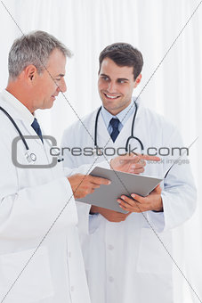 Smiling doctors interpreting results together