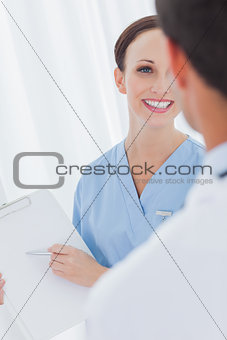 Cheerful pretty surgeon talking with a doctor