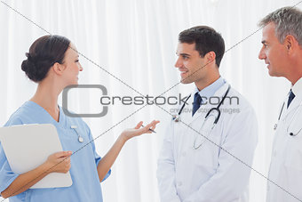 Doctors listening to their pretty workmate